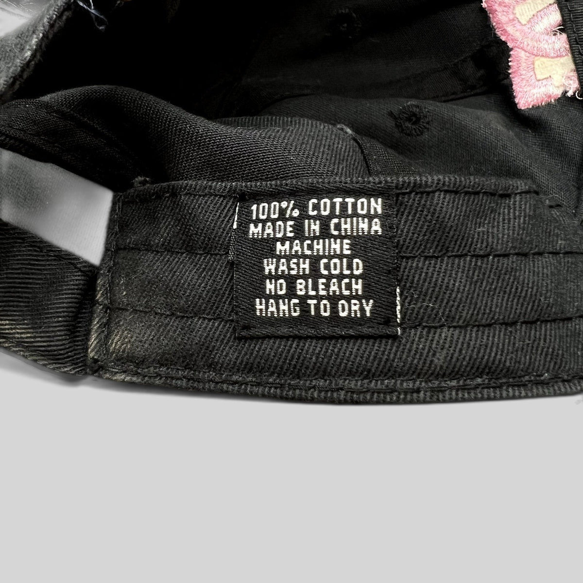 Raree Finds DC Shoes black cotton strapback hat interior care label showing 100 percent cotton material details