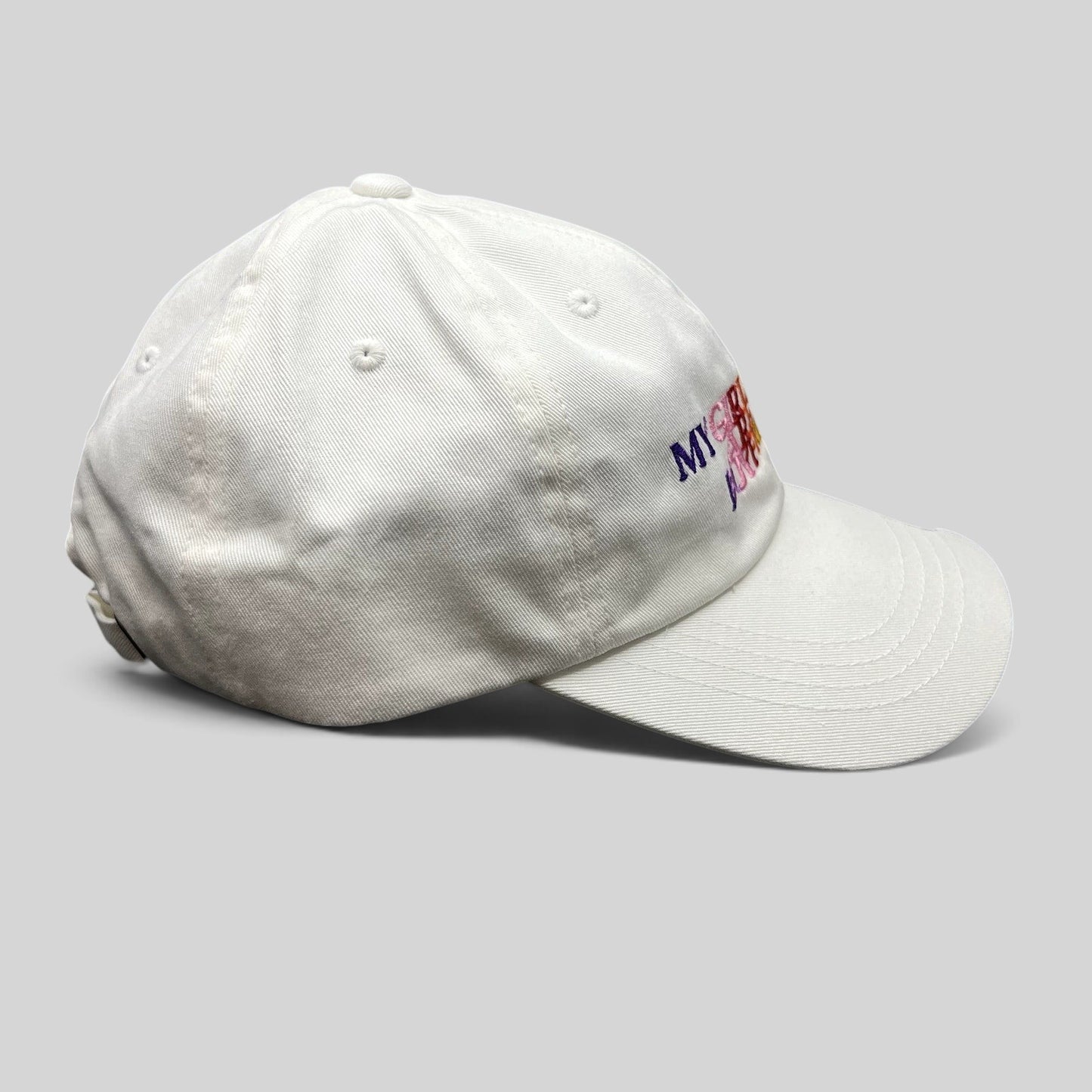 Raree Finds white Demi Lovato strapback hat with multicolor My Girlfriends Are My Boyfriend embroidery on side view