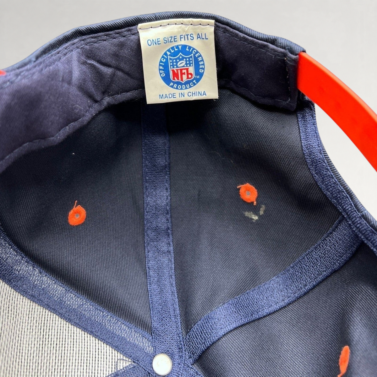 Raree Finds vintage Denver Broncos snapback interior showing NFL officially licensed tag and orange snap closure