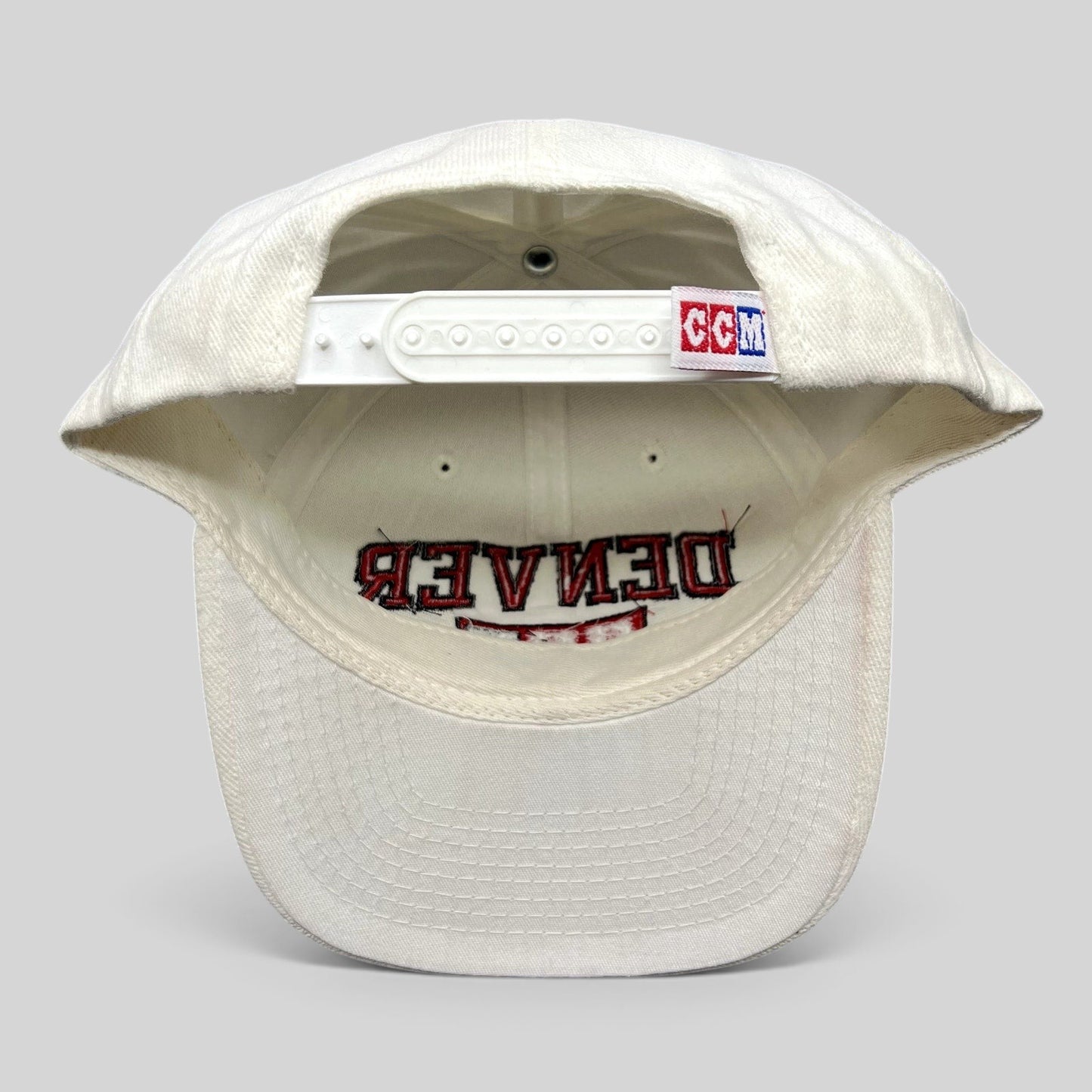 Raree Finds vintage white Denver Hockey snapback hat with CCM branding on the adjustable plastic snap closure