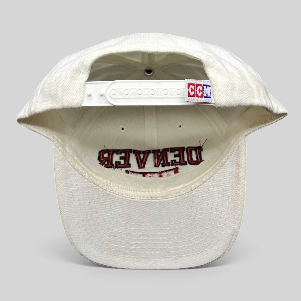 Raree Finds vintage white Denver Hockey snapback hat with CCM branding on the adjustable plastic snap closure