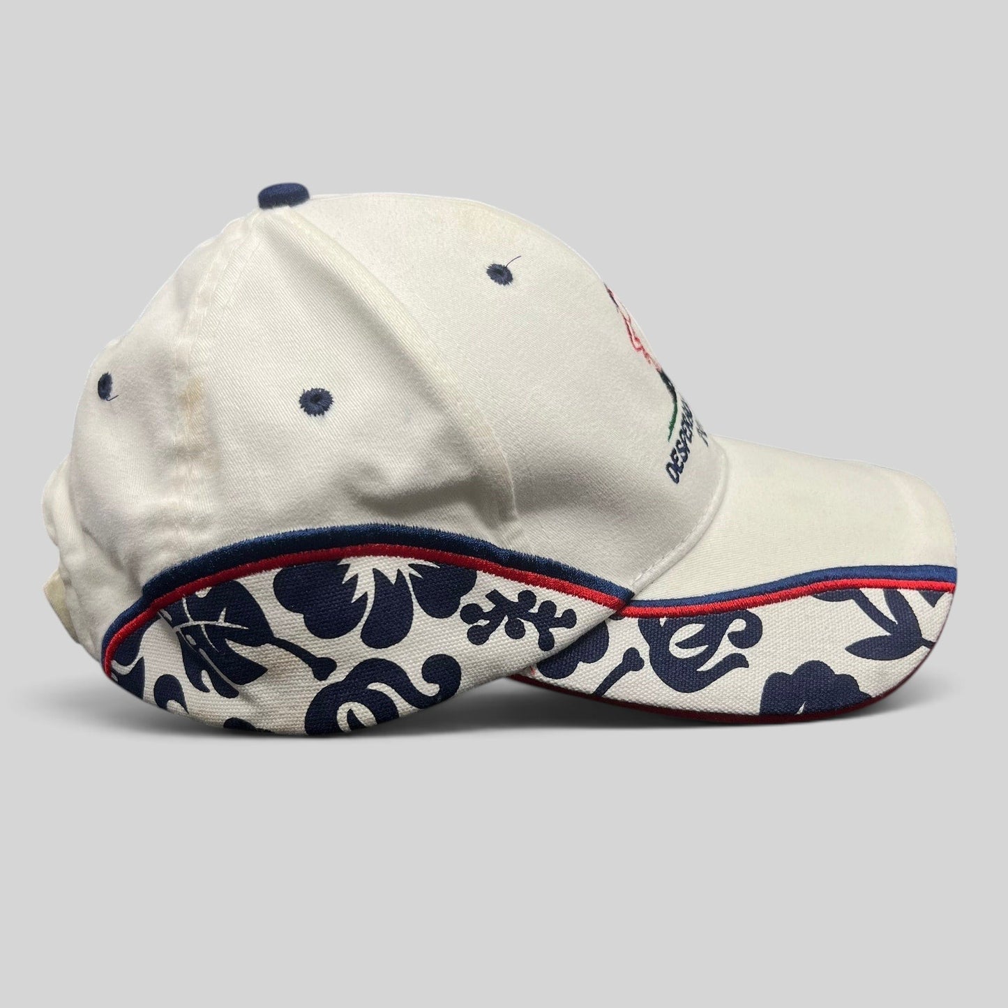 Raree Finds 2004 Desperado Golf Classic white cotton strapback hat with navy floral side panels and red trim