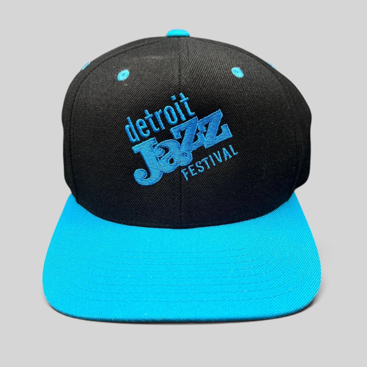 Raree Finds vintage Detroit Jazz Festival snapback hat with black crown, teal brim, and blue embroidered lettering.