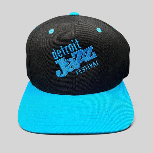 Raree Finds vintage Detroit Jazz Festival snapback hat with black crown, teal brim, and blue embroidered lettering.