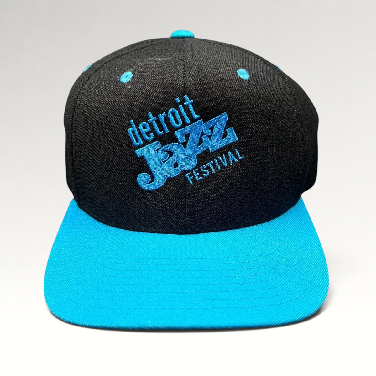 Raree Finds vintage Detroit Jazz Festival snapback hat with black crown, teal brim, and blue embroidered lettering.