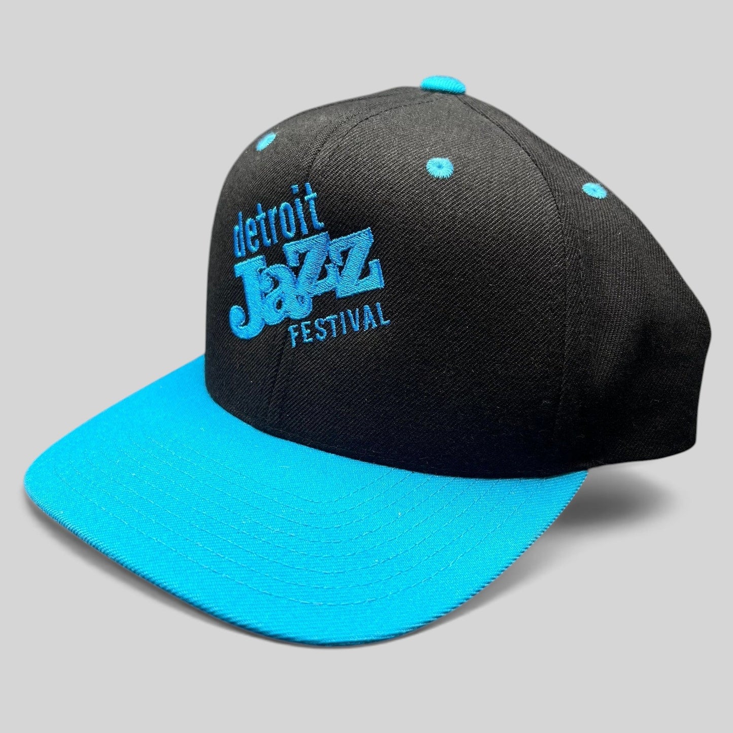 Raree Finds vintage Detroit Jazz Festival snapback hat with a black crown, teal brim, and blue embroidered lettering.