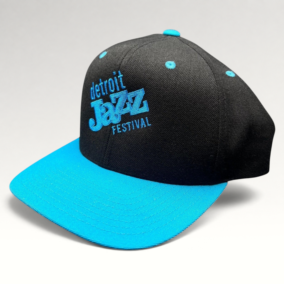 Raree Finds vintage Detroit Jazz Festival snapback hat with a black crown, teal brim, and blue embroidered lettering.