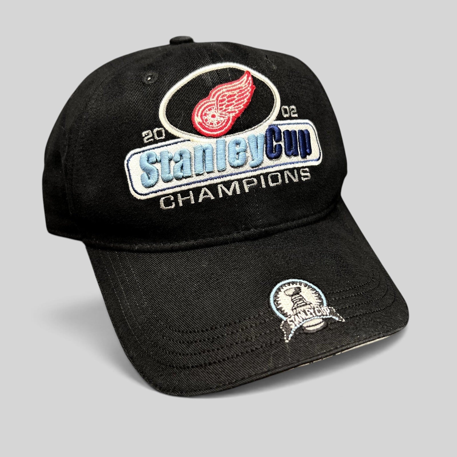 Raree Finds vintage 2002 Detroit Red Wings Stanley Cup Champions black strapback hat with embroidered brim patch
