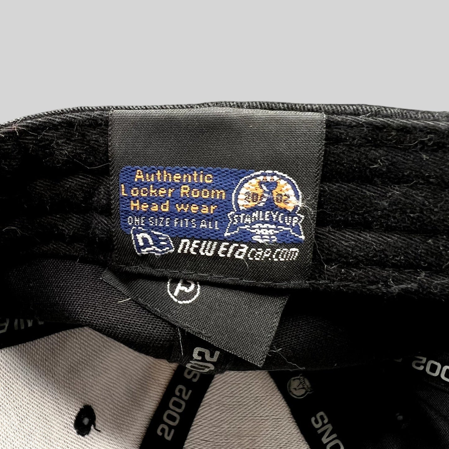 Raree Finds vintage 2002 Detroit Red Wings New Era locker room hat interior tag with Stanley Cup branding