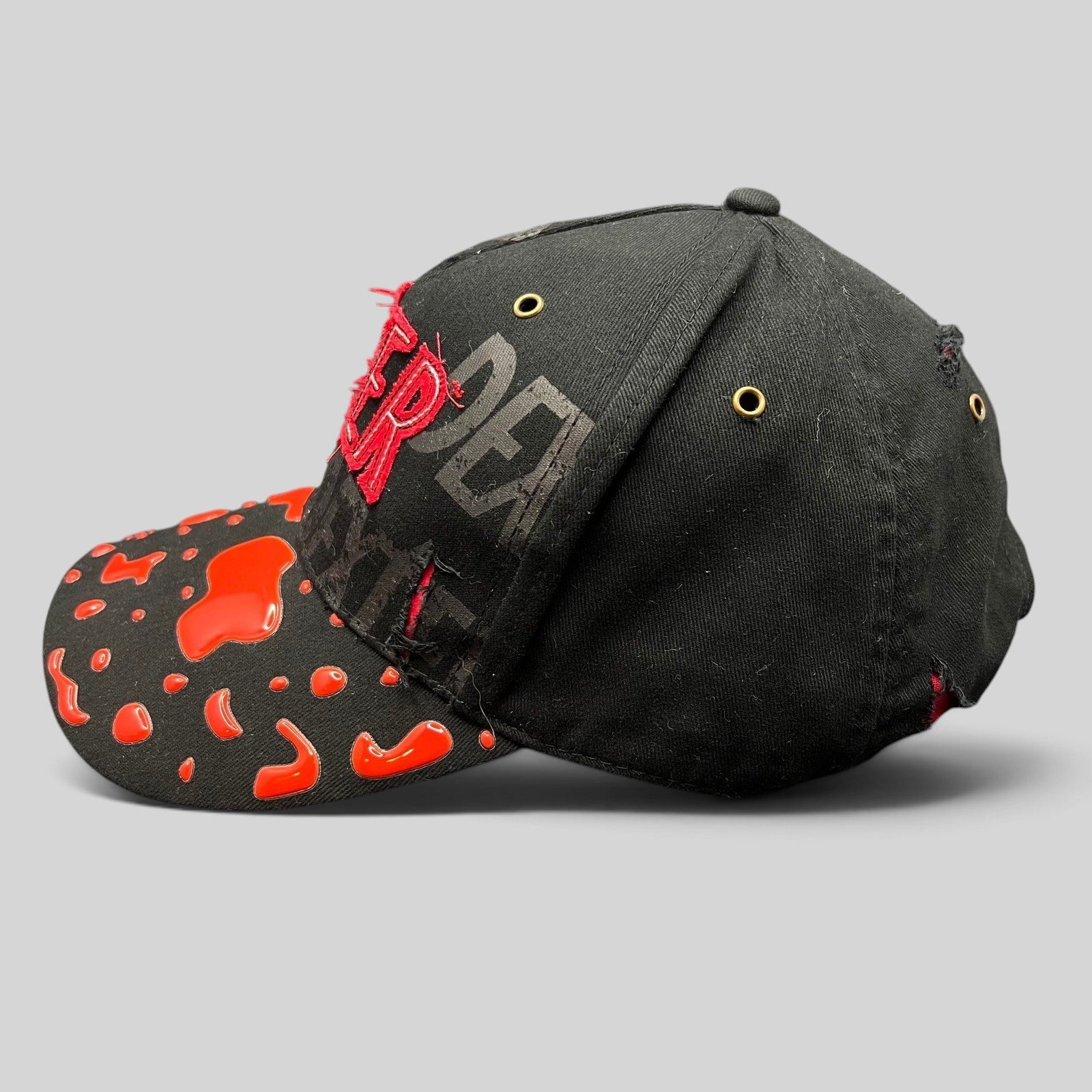 Raree Finds Dexter Showtime cast and crew promo hat in black with red blood splatter embroidery and distressed brim.