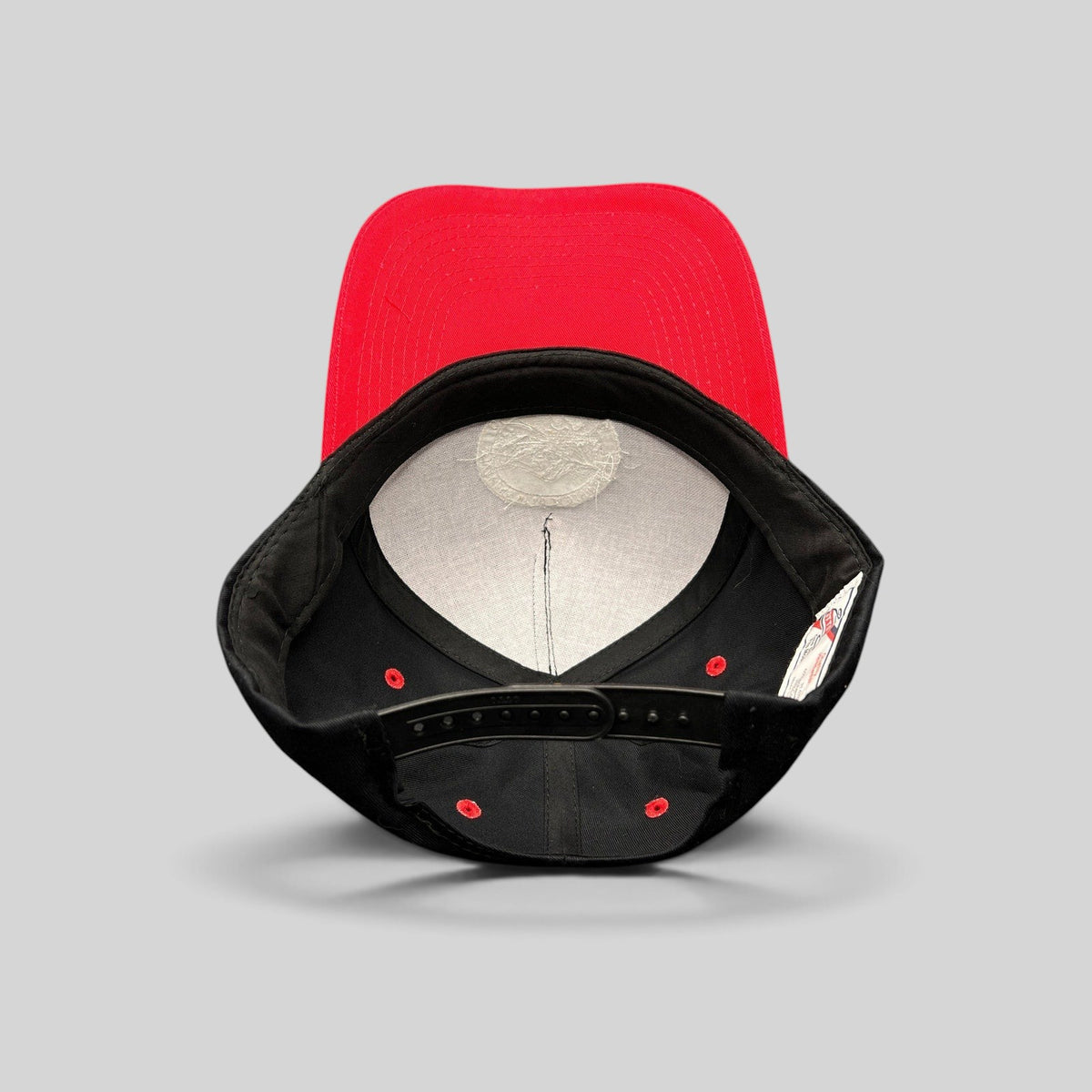 Raree Finds Diamond Head Clothing Co. snapback hat interior showing black crown, red brim, and adjustable strap.