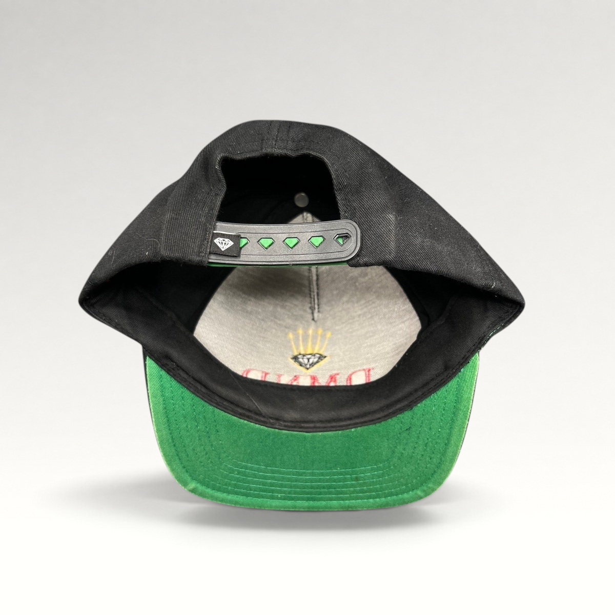 Raree Finds vintage Diamond Supply Co. black snapback hat with green underbrim and crown logo snapback closure