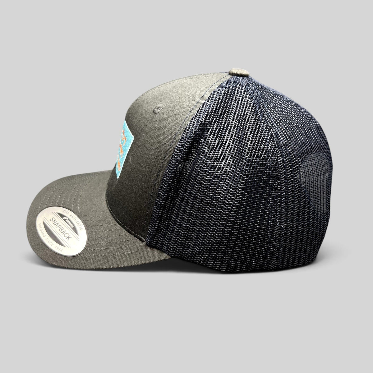 Raree Finds Diller Teen Fellows Yupoong Classics trucker hat in charcoal and navy with embroidered patch side view