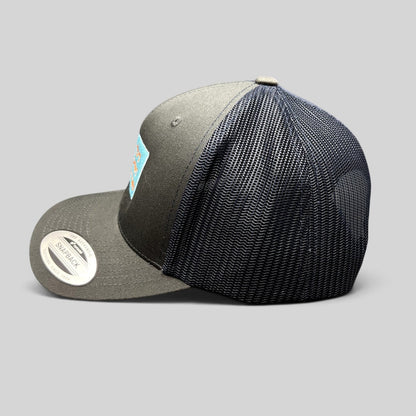 Raree Finds Diller Teen Fellows Yupoong Classics trucker hat in charcoal and navy with embroidered patch side view