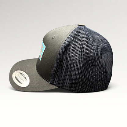 Raree Finds Diller Teen Fellows charcoal and navy Yupoong Classics trucker hat with mesh back and snapback closure.