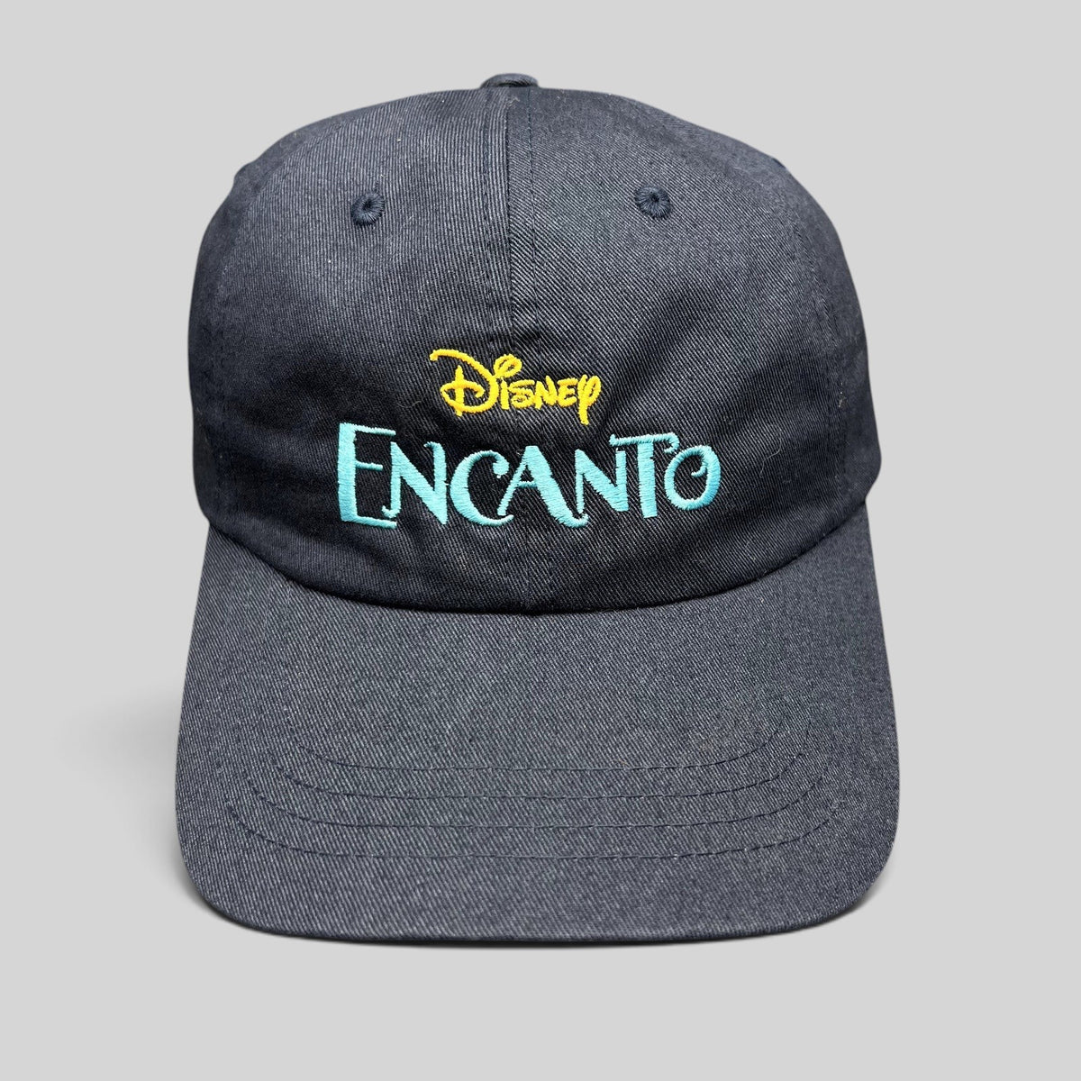Raree Finds navy blue cotton dad hat with embroidered Disney Encanto logo in gold and teal on the front