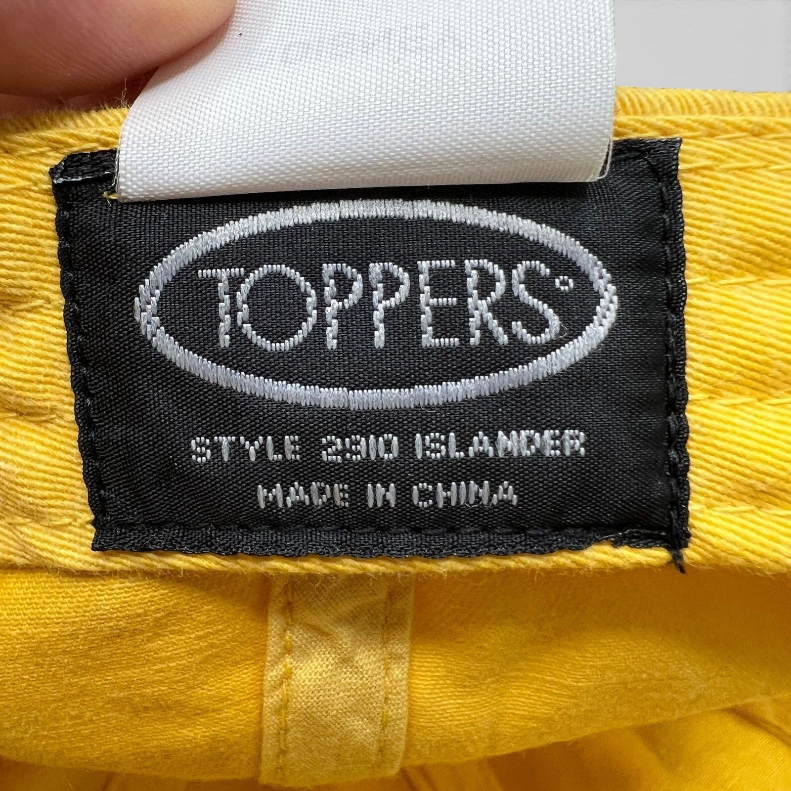 Raree Finds Disney VoluntEARS hat interior tag showing Toppers brand label on bright yellow cotton fabric