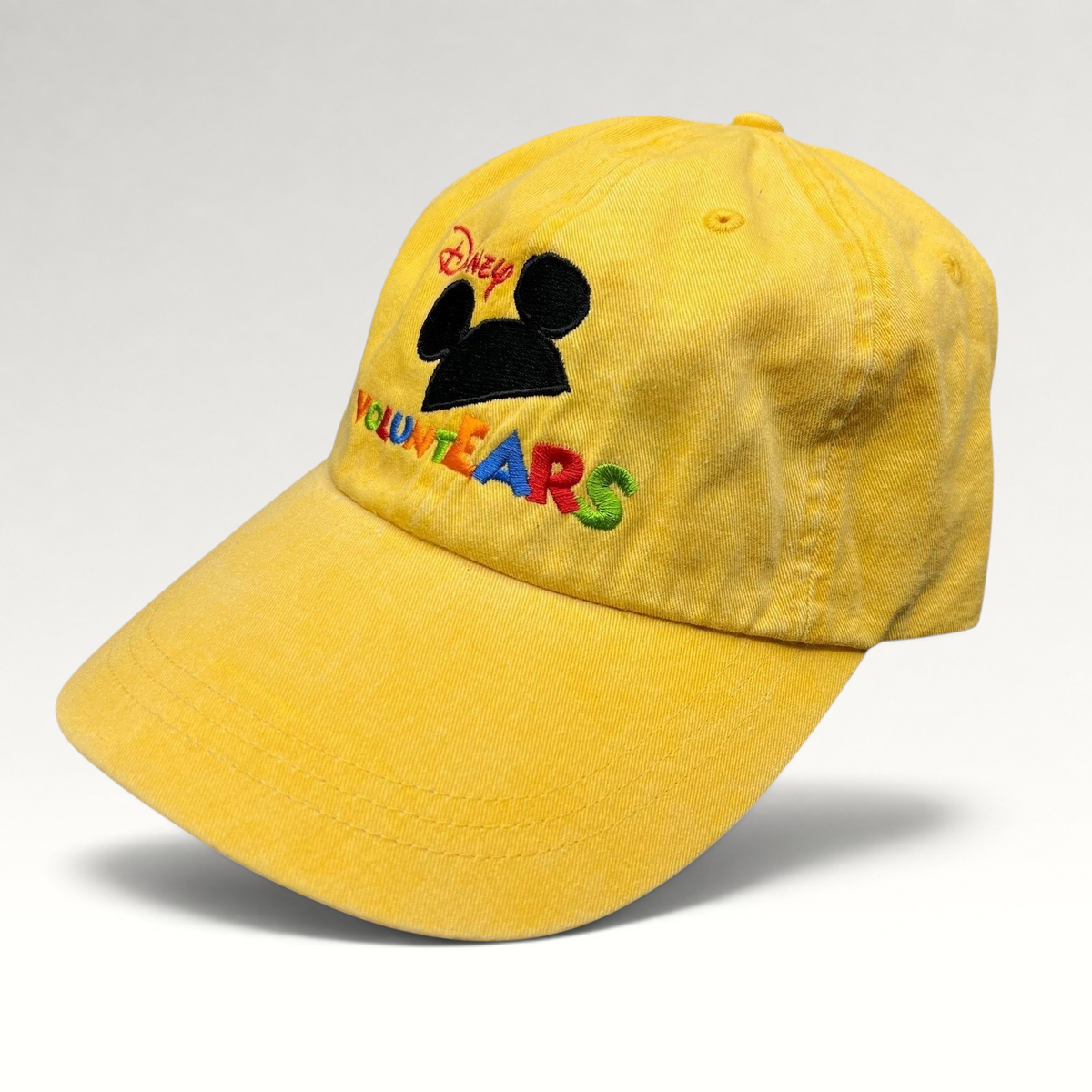 Raree Finds Disney VoluntEARS yellow cotton strapback hat with Mickey Mouse silhouette and colorful embroidery.