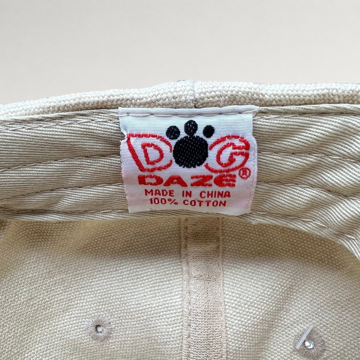 Raree Finds vintage Dog Daze brand tag inside an off-white cotton canvas strapback cap