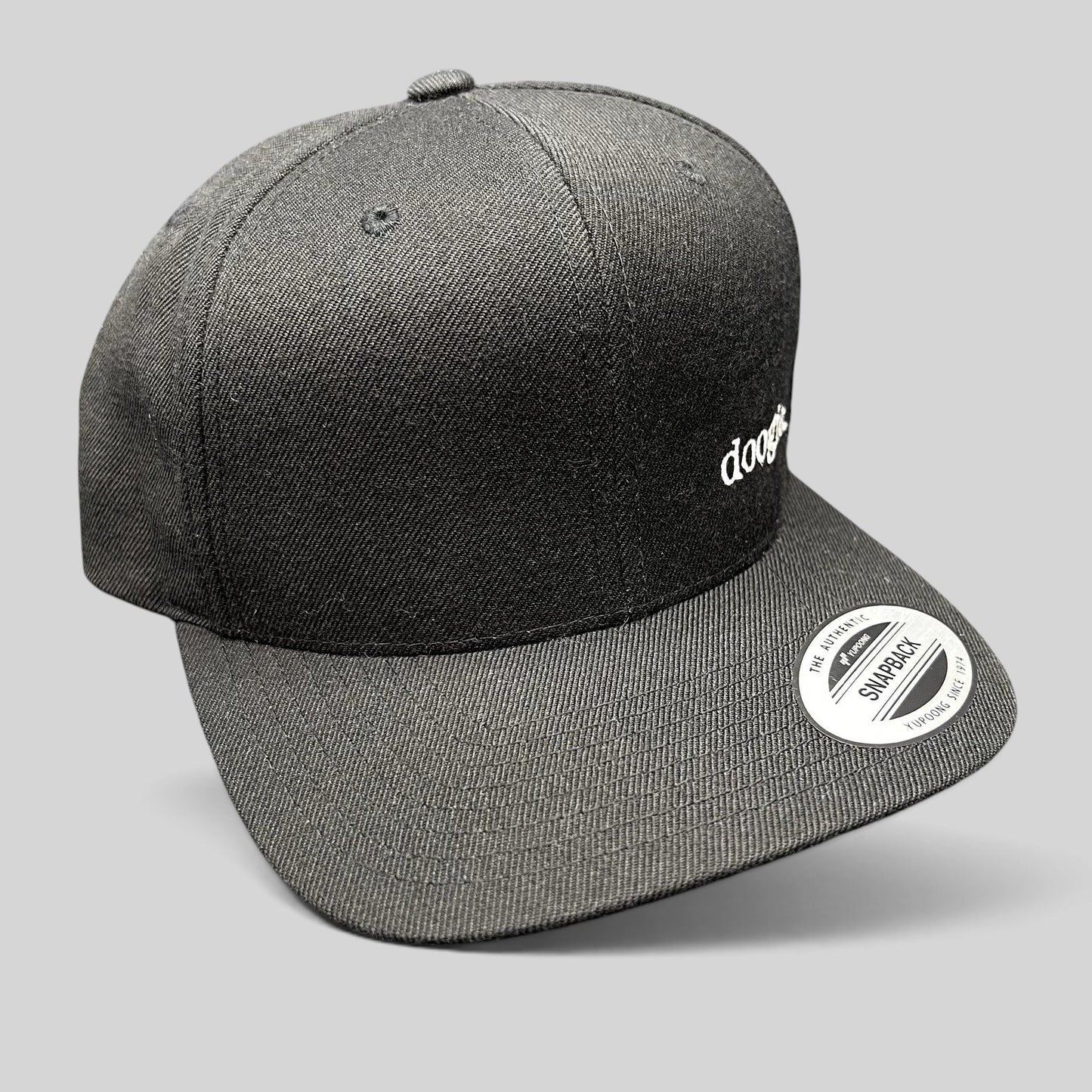 Raree Finds black Doogie Kamealoha M.D. snapback hat with white embroidered logo and Yupoong sticker on flat brim