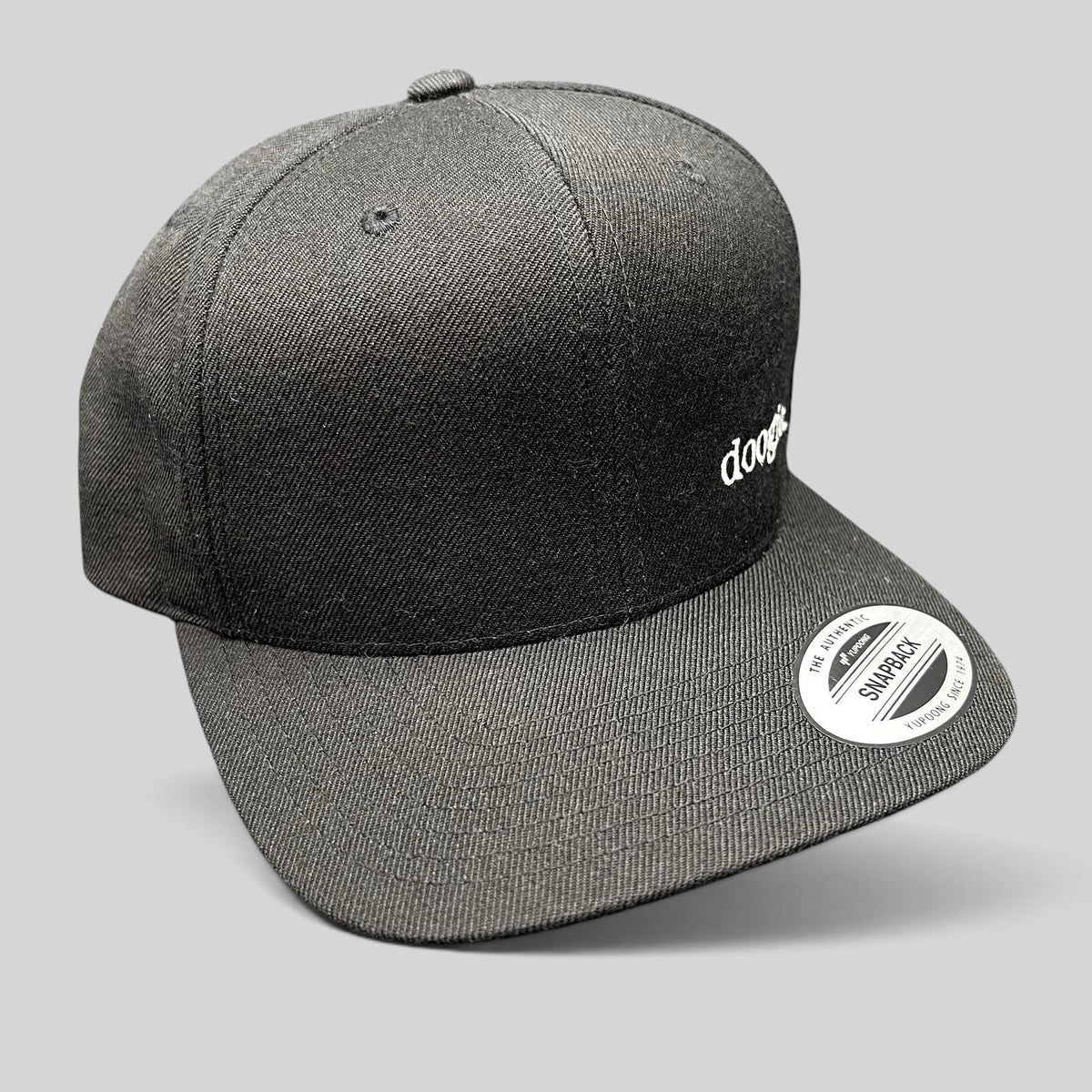 Raree Finds black Doogie Kamealoha M.D. snapback hat with white embroidered logo and Yupoong sticker on flat brim