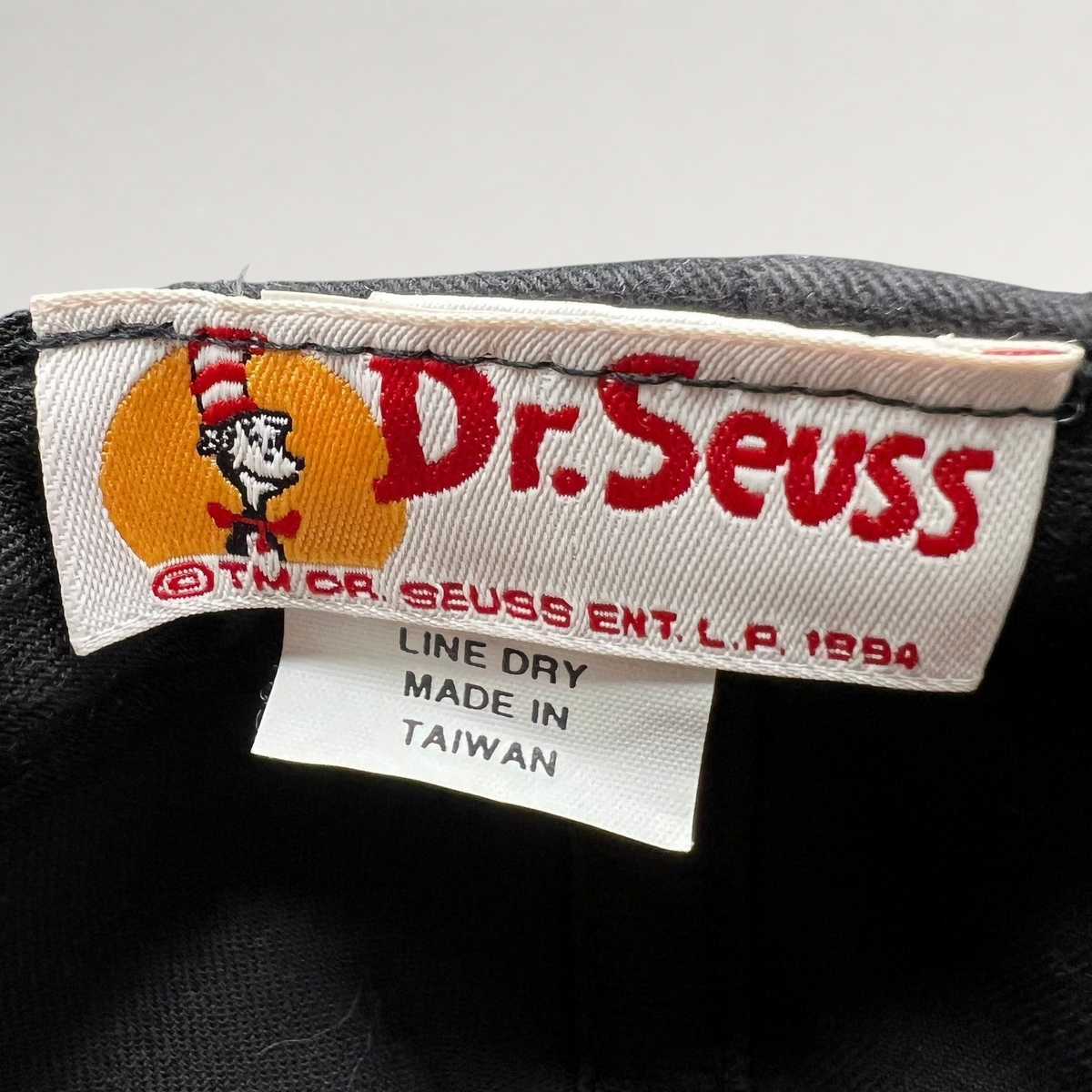Raree Finds vintage 1994 Dr. Seuss Cat in the Hat snapback hat interior tag showing brand and origin details