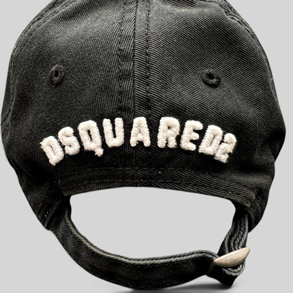 Raree Finds black DSQUARED2 strapback hat with white embroidered logo on the back and adjustable metal buckle closure.
