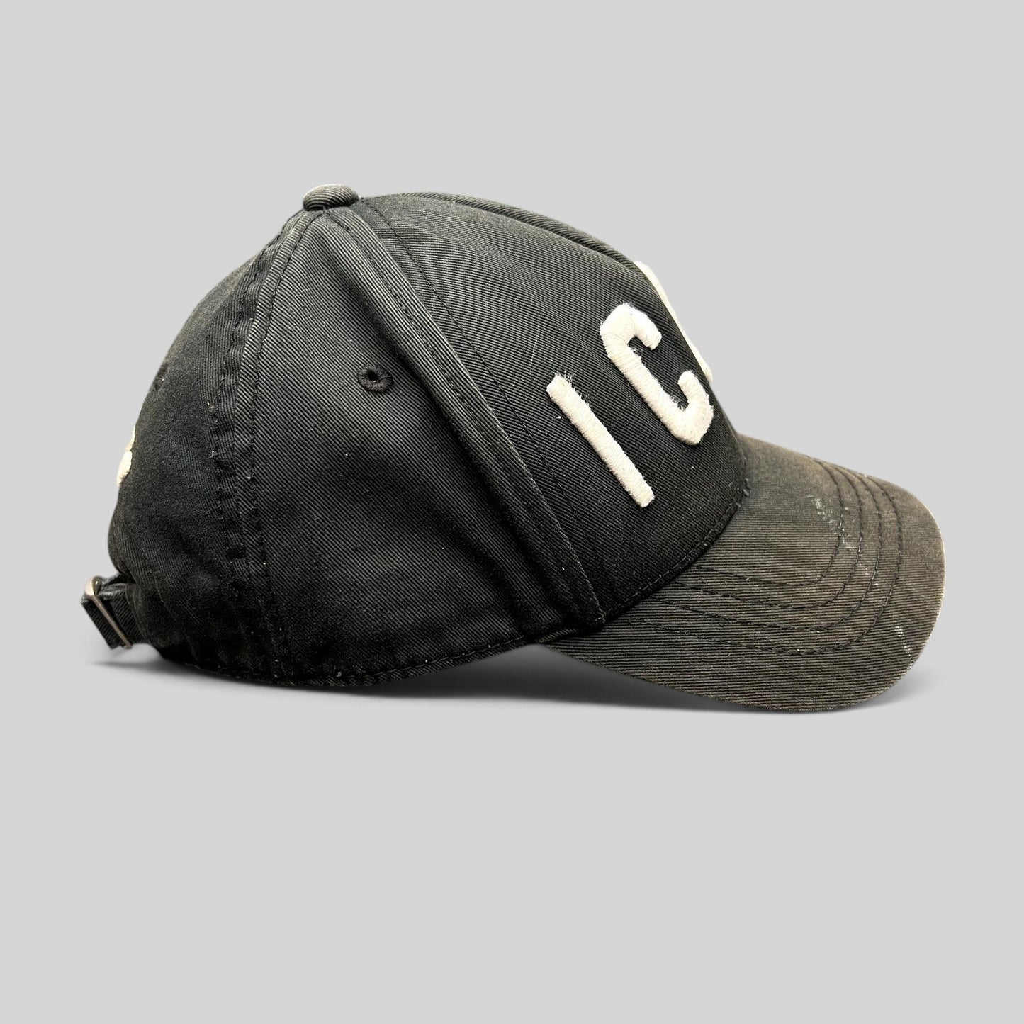 Raree Finds black DSQUARED2 ICON strapback hat with raised white embroidery and curved brim side view