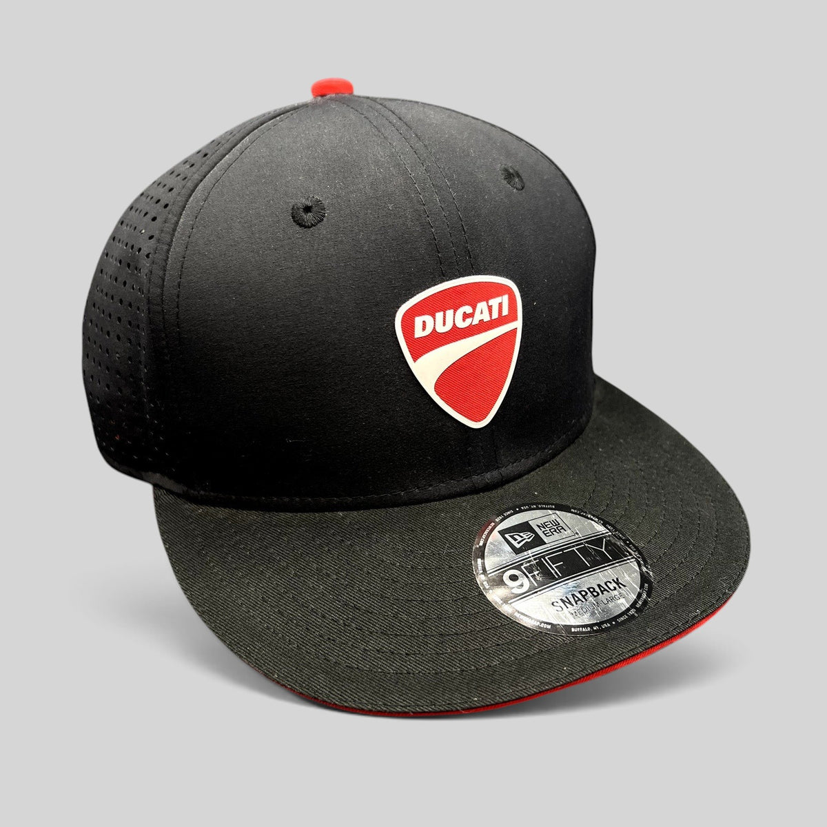 Raree Finds black New Era 9FIFTY Ducati snapback hat with red shield logo, flat brim, and perforated back panels.