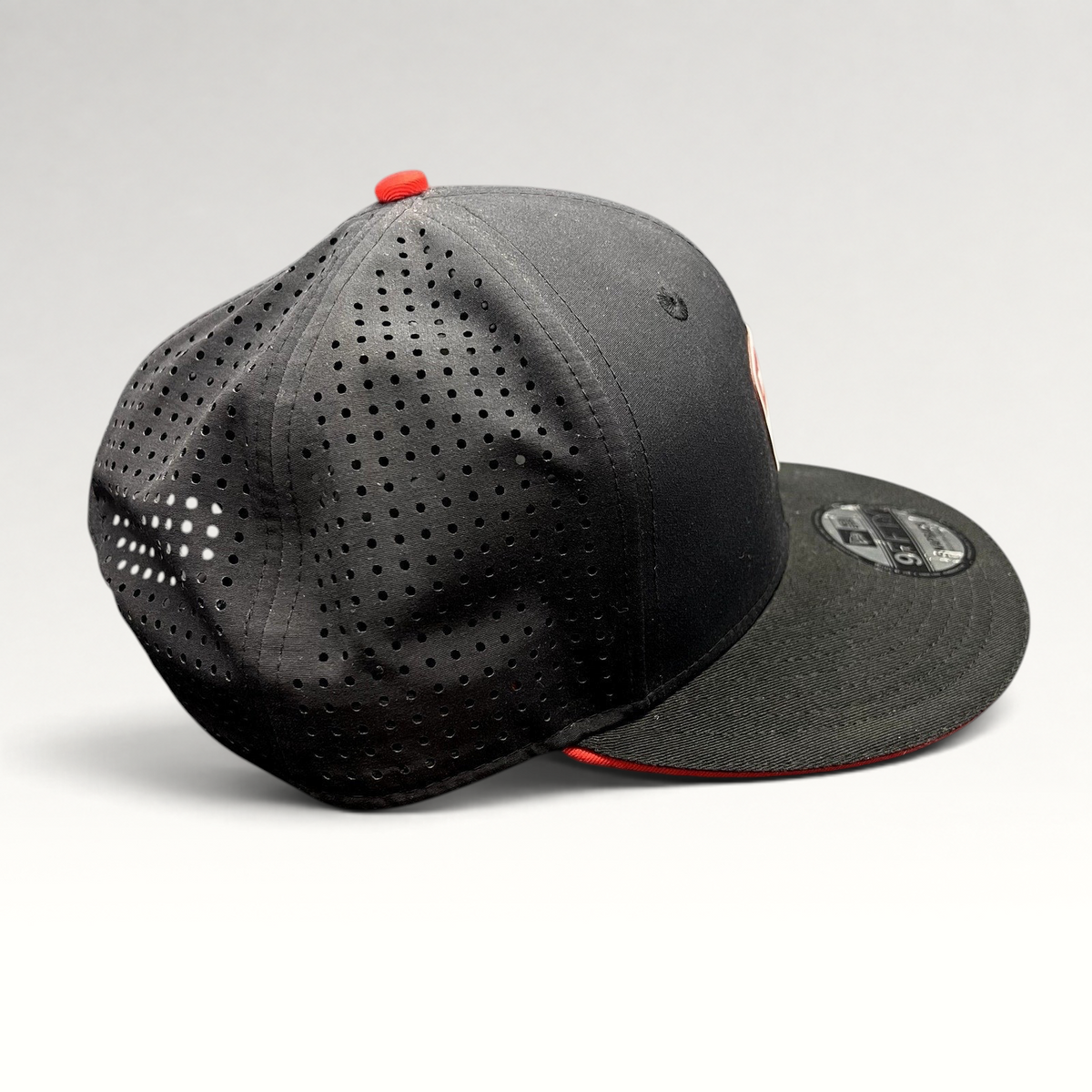 Raree Finds black New Era 9FIFTY Ducati snapback hat with laser-perforated rear panels and red button detail