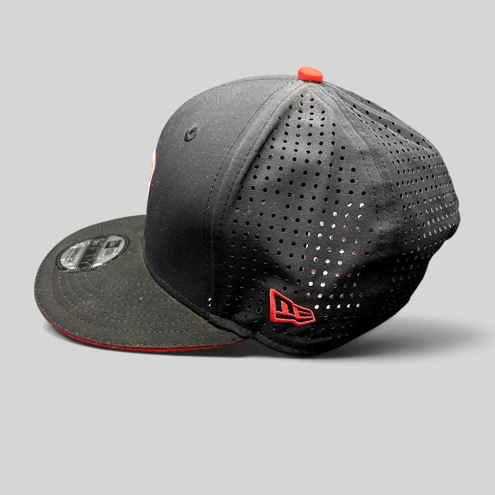 Raree Finds black New Era 9FIFTY Ducati snapback hat with laser-perforated rear panels and red embroidered logo