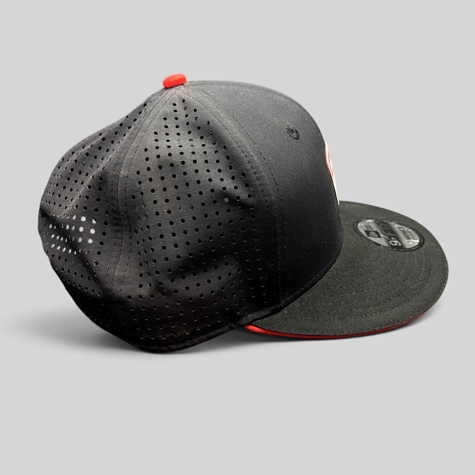 Raree Finds black New Era 9FIFTY Ducati snapback cap with laser-perforated rear panels and red button detail
