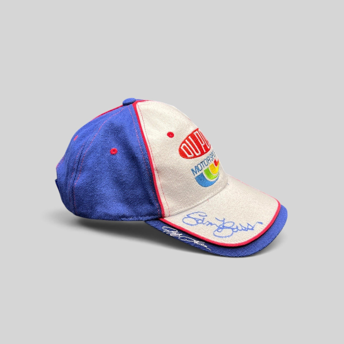Raree Finds vintage DuPont Motorsports NASCAR snapback hat in white and royal blue cotton with rainbow embroidery.