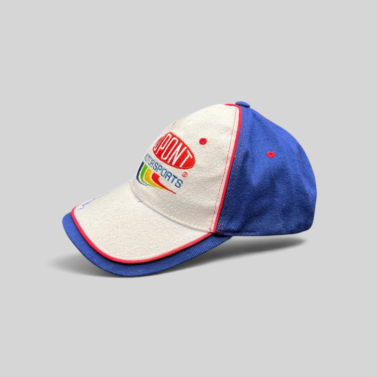 Raree Finds vintage DuPont Motorsports NASCAR snapback hat in white and royal blue cotton with rainbow embroidery.