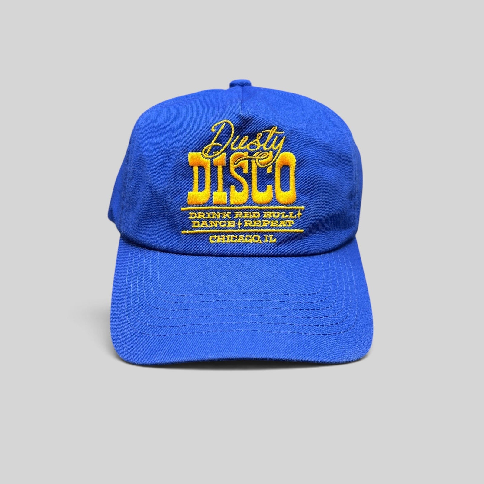 Raree Finds vintage royal blue snapback hat with yellow Dusty Disco Chicago embroidery and adjustable back closure.