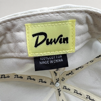 Raree Finds Duvin Beach Club hat interior showing yellow brand label and 100% cotton tag on white fabric