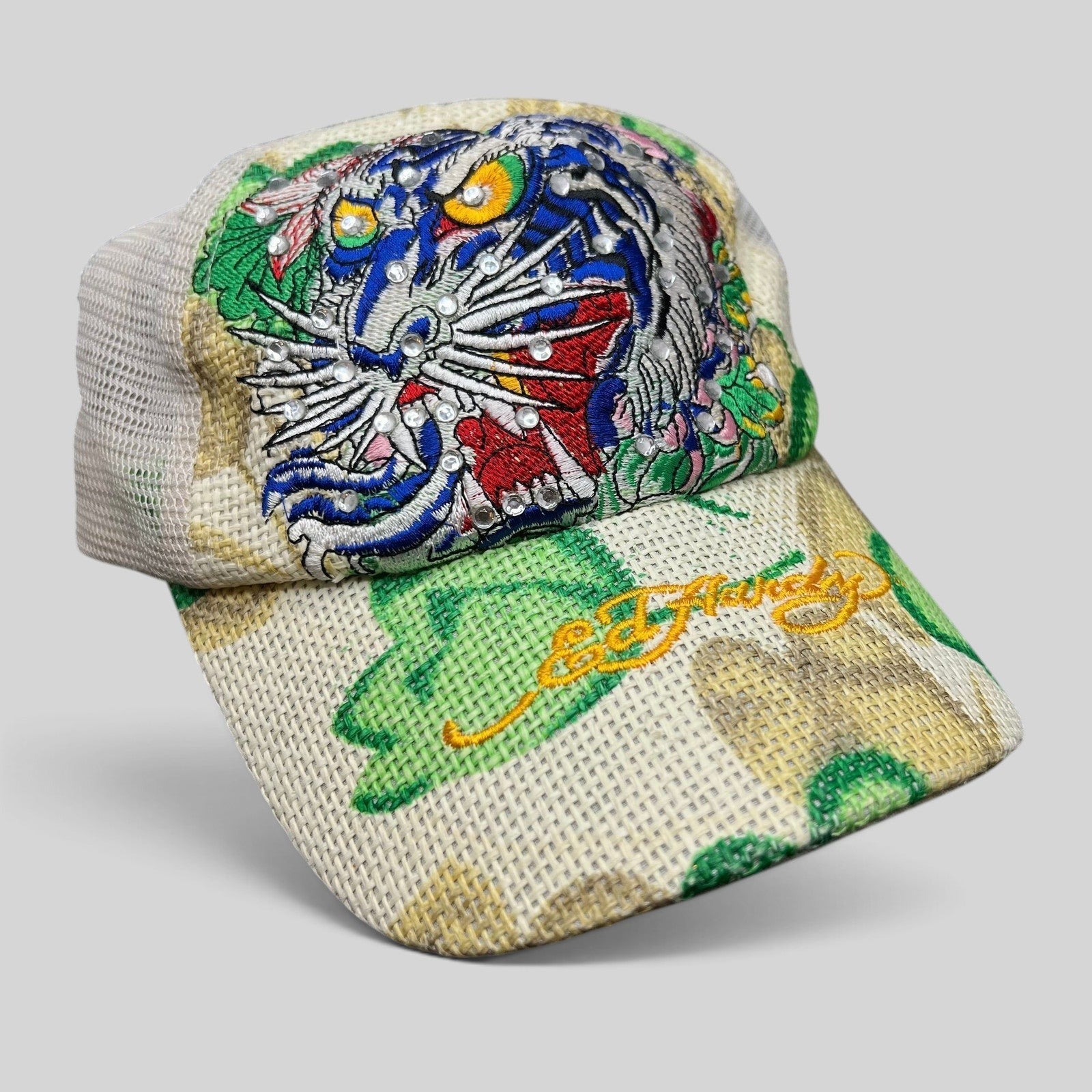 Raree Finds vintage Ed Hardy trucker hat with tiger embroidery, rhinestone accents, and a natural canvas mesh design.
