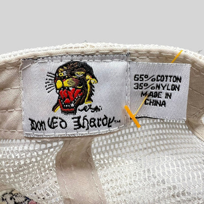 Raree Finds Don Ed Hardy trucker hat interior tag showing tiger logo, material composition, and origin details.