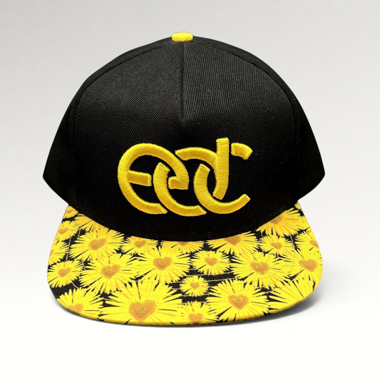 Raree Finds Insomniac EDC snapback hat with a black crown, yellow embroidered logo, and sunflower print flat brim.
