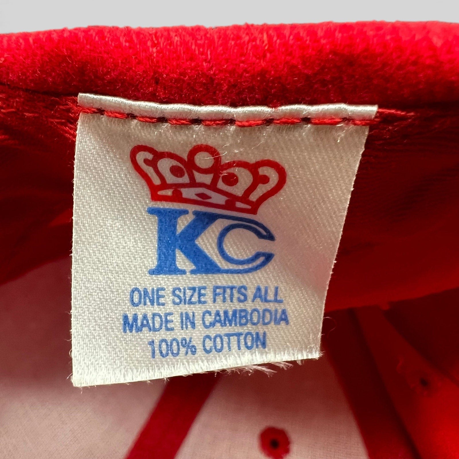 Raree Finds Edmiston snapback hat interior tag showing KC crown logo, 100% cotton material, and one size fits all.