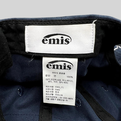 Raree Finds EMIS navy cotton strapback hat interior label and care tag showing 100 percent cotton composition