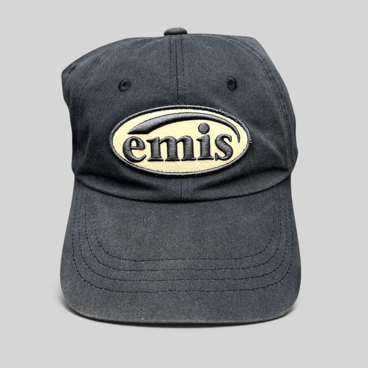Raree Finds navy cotton strapback hat by EMIS featuring a cream oval logo embroidery on the front