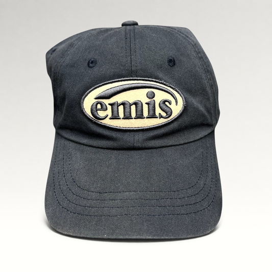 Raree Finds navy cotton strapback hat by EMIS featuring a cream oval logo embroidery on the front