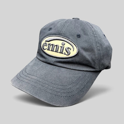 Raree Finds navy EMIS cotton strapback hat with a cream oval logo embroidery on the front and a curved brim.