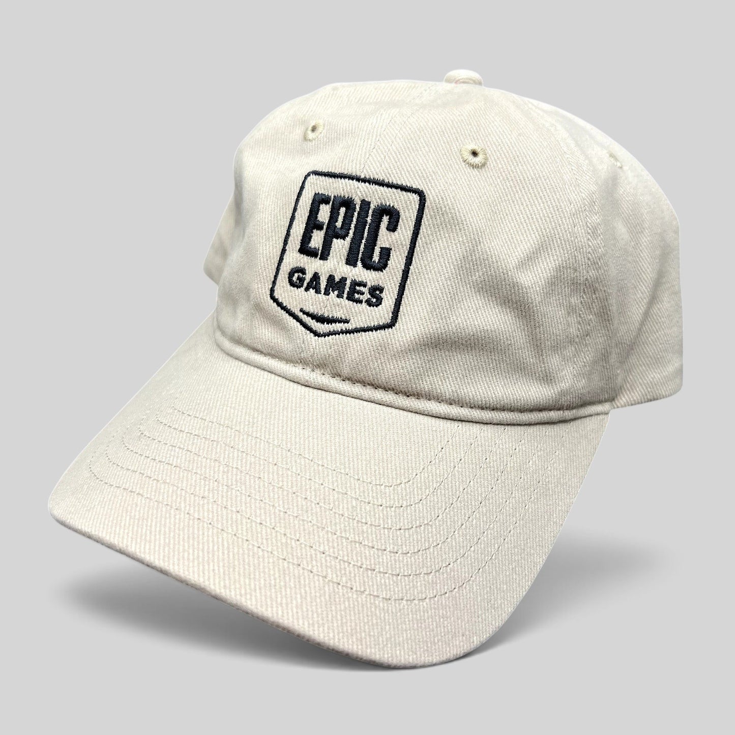 Raree Finds beige cotton twill dad cap with an embroidered Epic Games shield logo on the front and a curved brim.