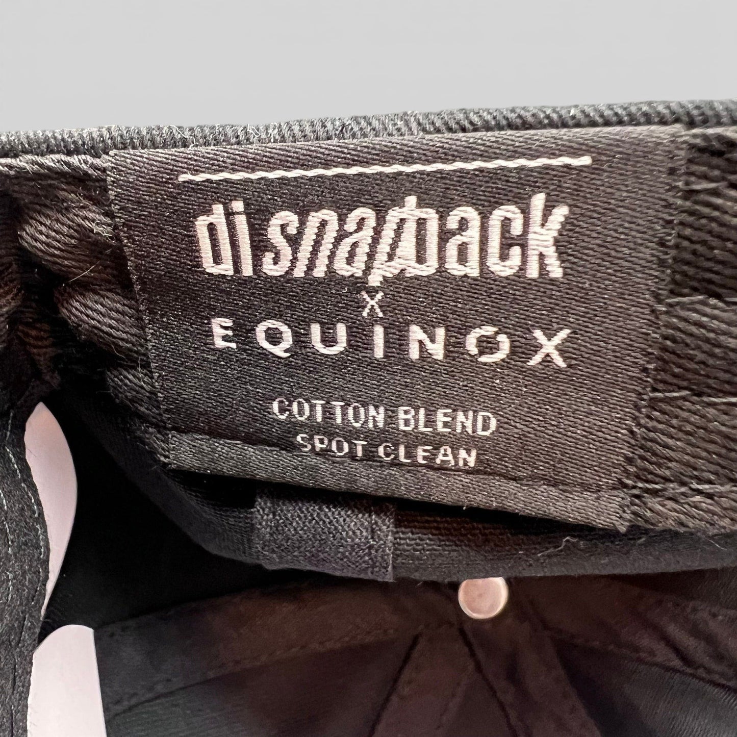 Raree Finds Equinox x DI Snapback black cotton blend hat interior label with branding and care instructions