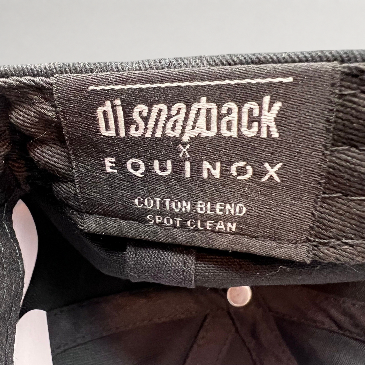 Raree Finds Equinox x DI Snapback black cotton blend hat interior label with branding and care instructions