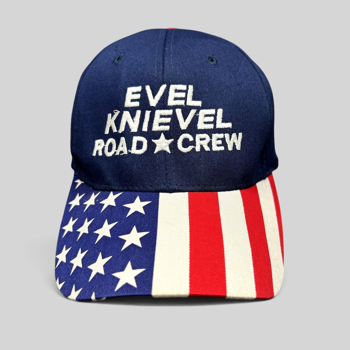Raree Finds vintage Y2K Evel Knievel Road Crew navy blue strapback hat with an American flag print curved brim.
