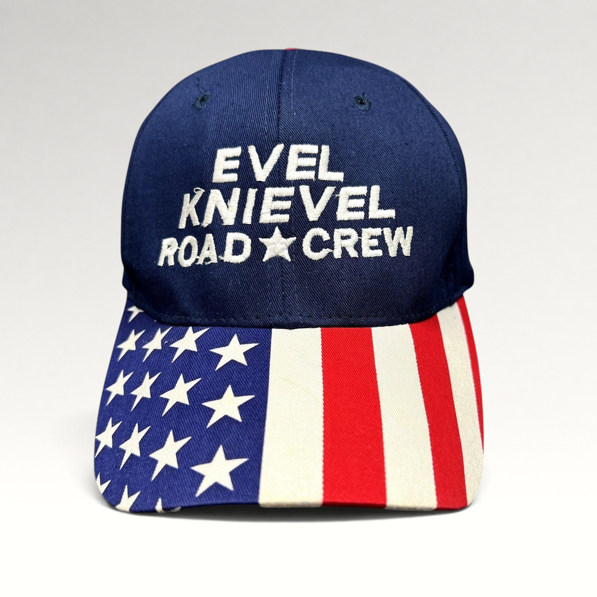 Raree Finds vintage Y2K Evel Knievel Road Crew navy blue strapback hat with an American flag print curved brim.