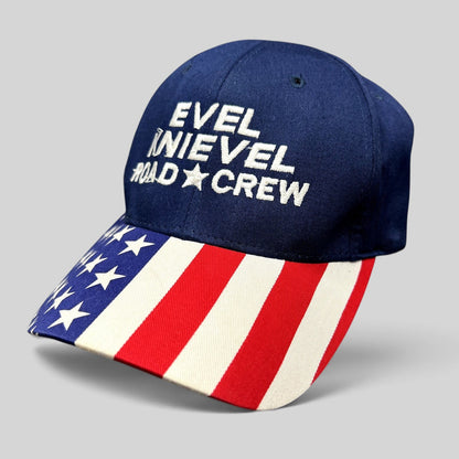 Raree Finds Y2K Evel Knievel Road Crew strapback hat with navy crown and patriotic American flag print curved brim.